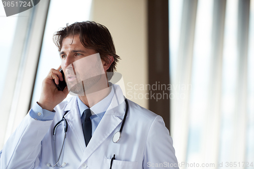 Image of doctor speaking on cellphone