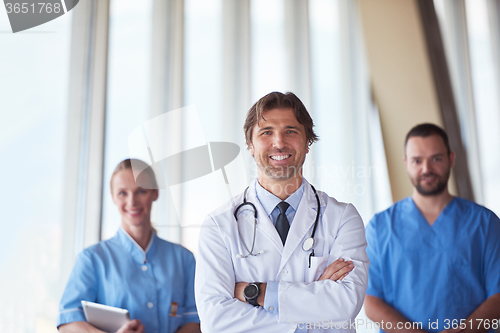 Image of group of medical staff at hospital, handsome doctor in front of 