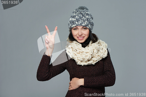 Image of Woman giving peace sign