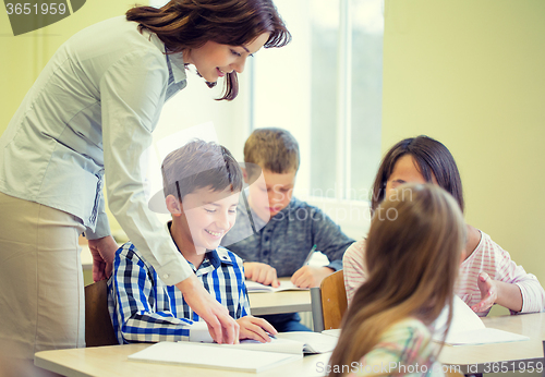 Image of group of school kids writing test in classroom