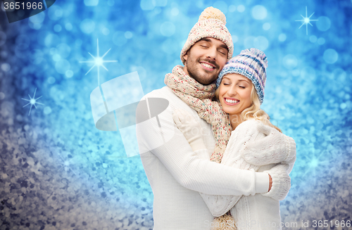 Image of smiling couple in winter clothes hugging