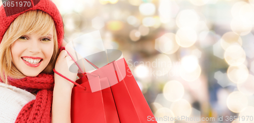 Image of smiling young woman with shopping bags