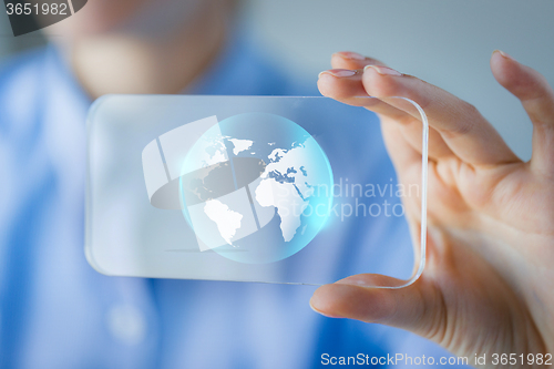 Image of close up of woman with transparent smartphone