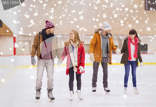 Image of happy friends on skating rink