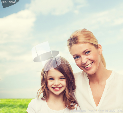 Image of smiling mother and little girl