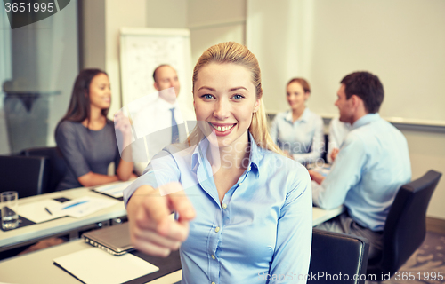 Image of group of smiling businesspeople meeting in office
