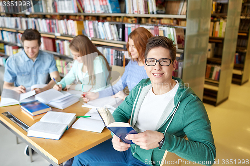 Image of students with books preparing to exam in library