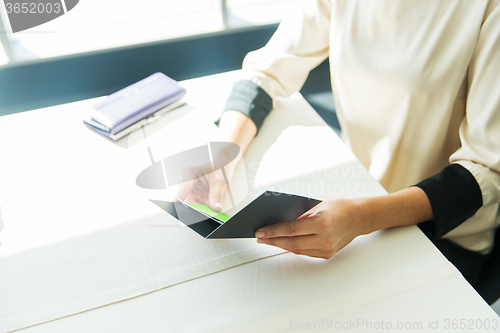 Image of close up of woman hands holding restaurant bill