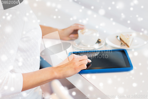 Image of close up of woman with tablet pc drinking coffee