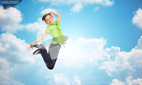 Image of smiling boy jumping in air