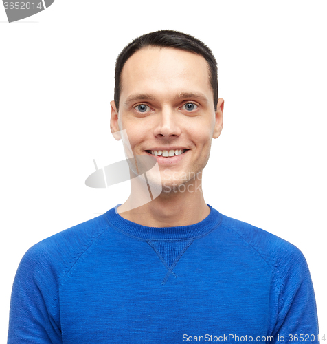 Image of smiling young man in blue pullover portrait