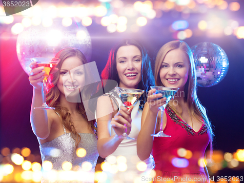 Image of smiling women with cocktails at night club