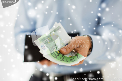 Image of close up of businessman hands holding money