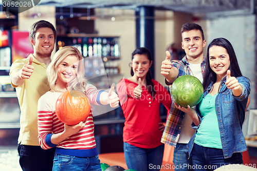 Image of happy friends in bowling club