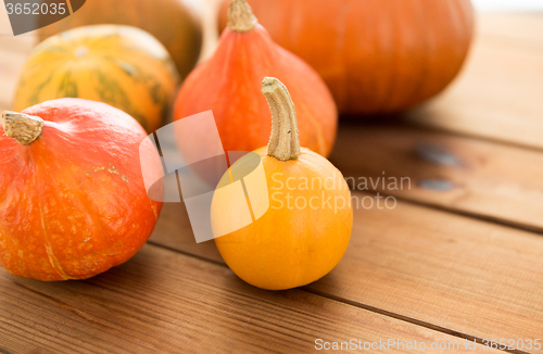 Image of close up of pumpkins on wooden table at home