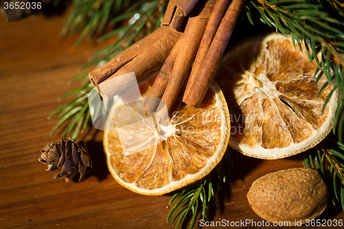 Image of christmas fir branch, cinnamon and dried orange