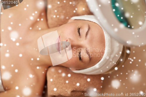 Image of close up of young woman face in spa salon