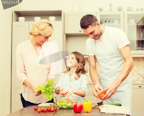 Image of happy family making dinner in kitchen