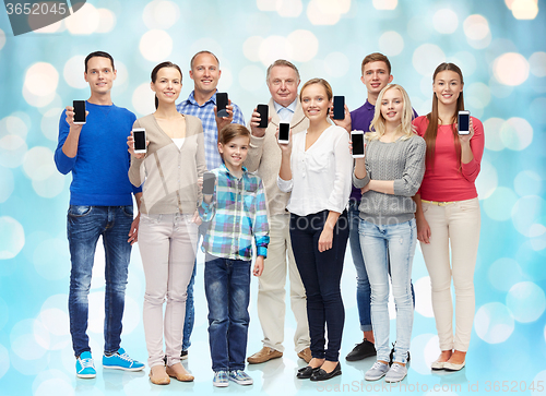 Image of group of smiling people with smartphones
