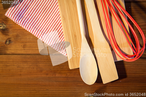 Image of close up of cooking kitchenware on wooden board