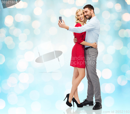 Image of happy couple taking selfie with smartphone