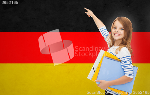 Image of happy student girl with folders pointing finger