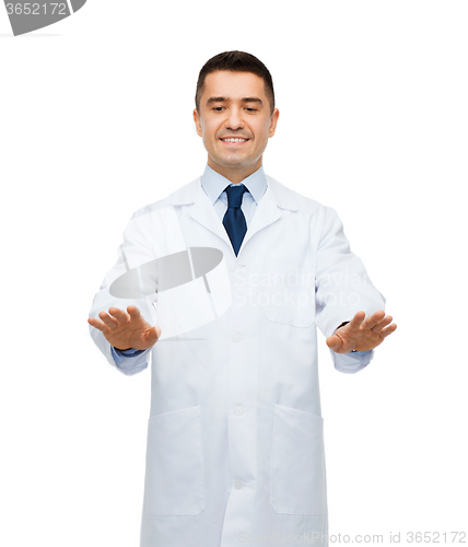 Image of smiling male doctor touching something