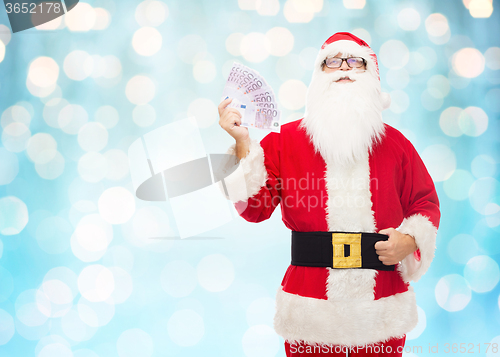 Image of man in costume of santa claus with euro money