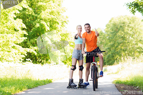 Image of couple on rollerblades and bike showing thumbs up