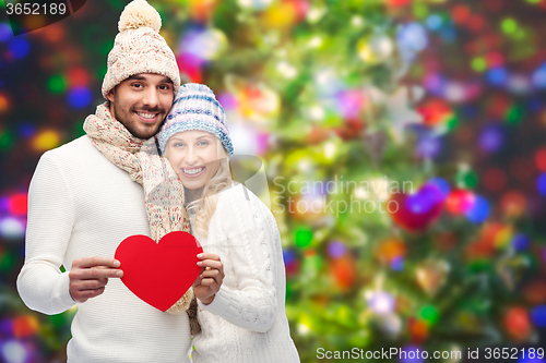 Image of smiling couple in winter clothes with red hearts