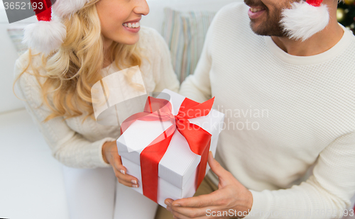 Image of close up of couple with christmas gift at home