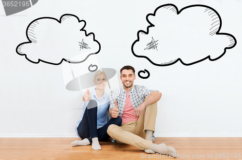 Image of happy couple showing thumbs up at new home