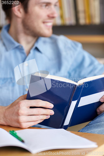 Image of close up of student reading book at school