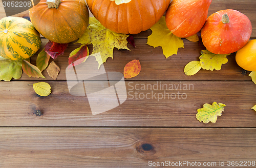 Image of close up of pumpkins on wooden table at home