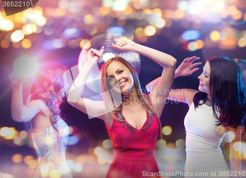 Image of happy women dancing at night club