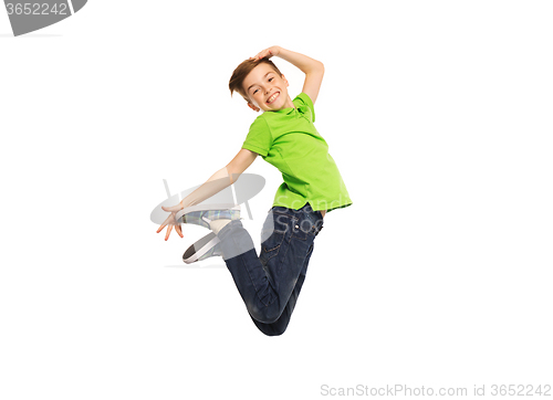 Image of smiling boy jumping in air