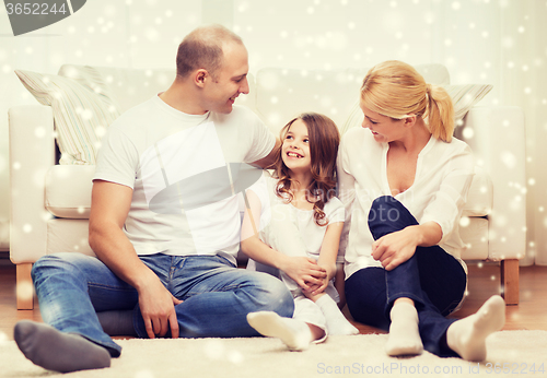 Image of smiling parents and little girl at home