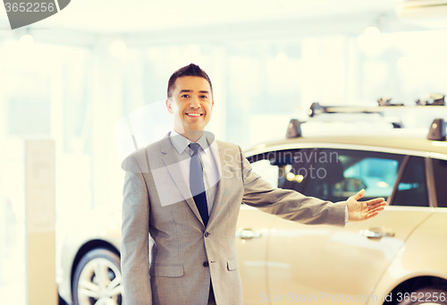 Image of happy man at auto show or car salon