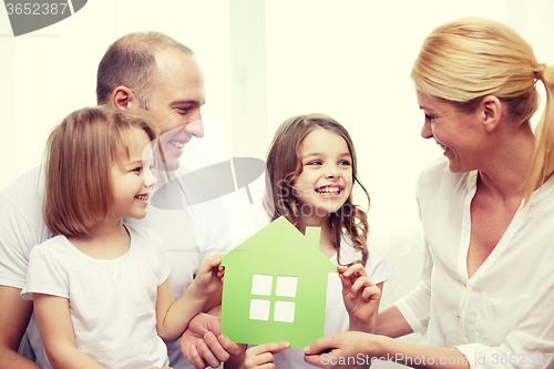 Image of smiling parents and two little girls at new home