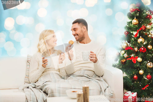 Image of happy couple at home with christmas tree