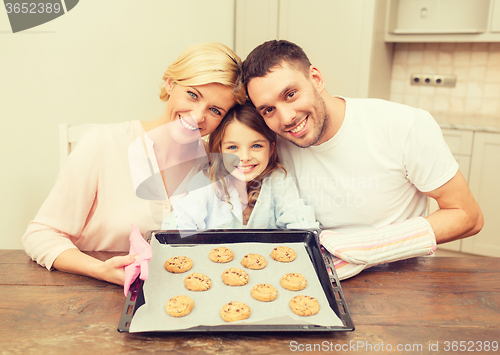 Image of happy family making cookies at home