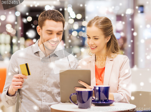 Image of couple with tablet pc and credit card in mall