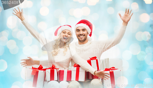 Image of happy couple at home with christmas gift boxes