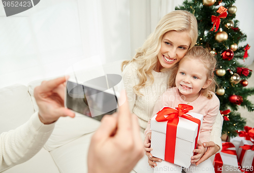 Image of family taking picture with smartphone at christmas