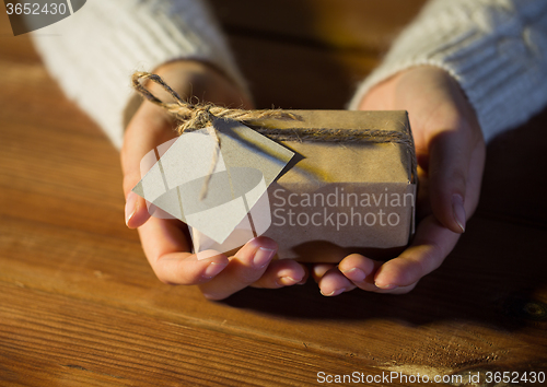 Image of close up of woman with christmas gift or parcel