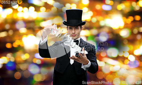 Image of magician showing trick with playing cards