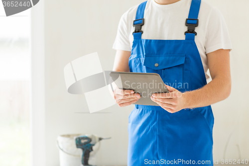 Image of close up of builder or workman with tablet pc