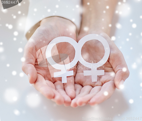 Image of close up of happy lesbian couple with venus symbol