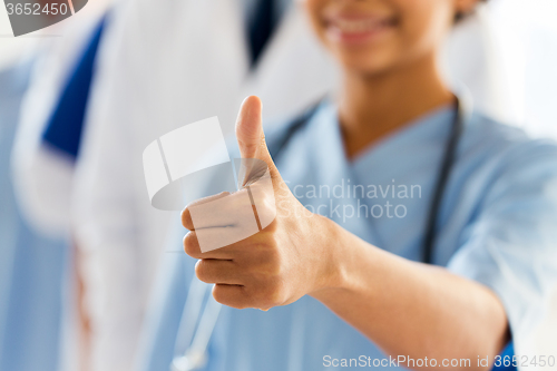 Image of close up of doctor or nurse showing thumbs 