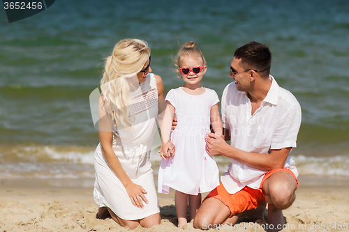 Image of happy family in sunglasses on summer beach